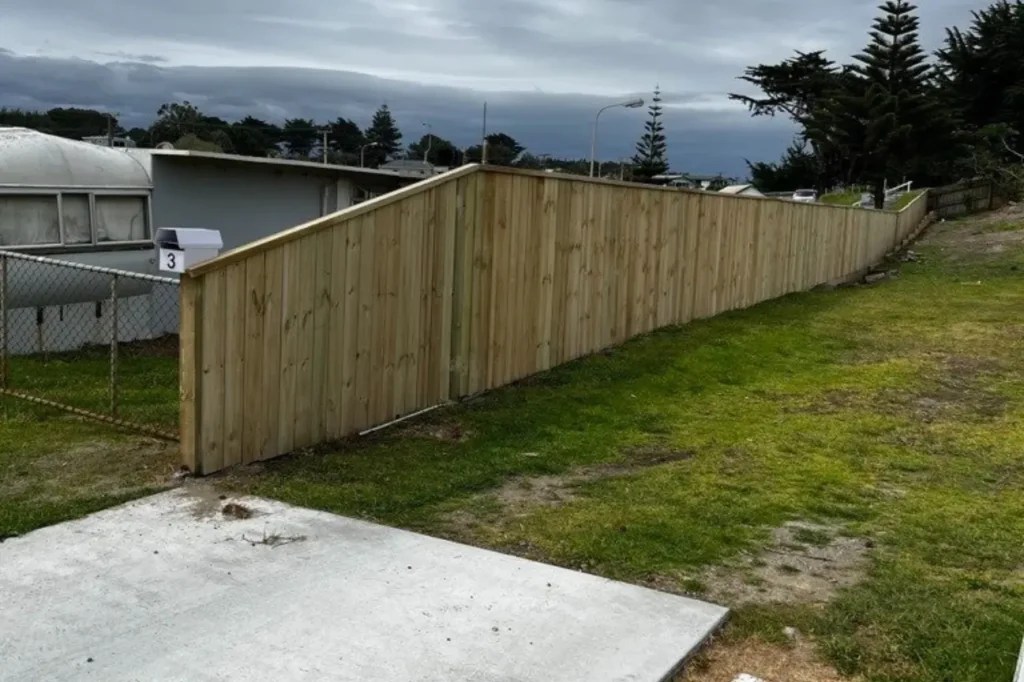 Professional installation of a long vertical paling timber fencing boundary by Fence Builders Palmerston North.