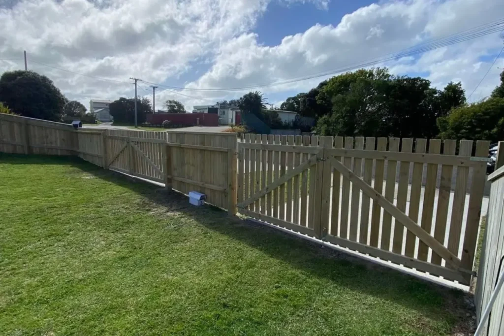 Custom timber fencing featuring a functional wooden gate installed by Fence Builders Palmerston North.