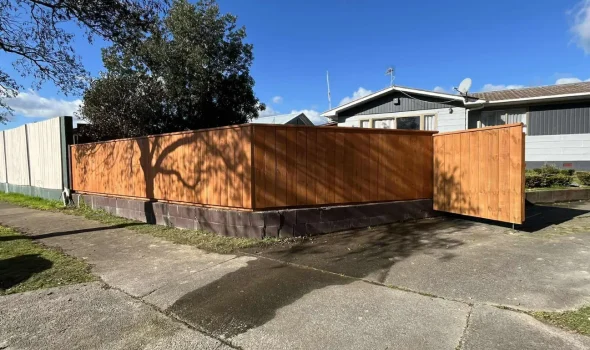 Durability and Longevity Timber Fencing Fence Builders Palmerston North Sturdy and durable timber fencing installed on a concrete retaining wall by Fence Builders Palmerston North.